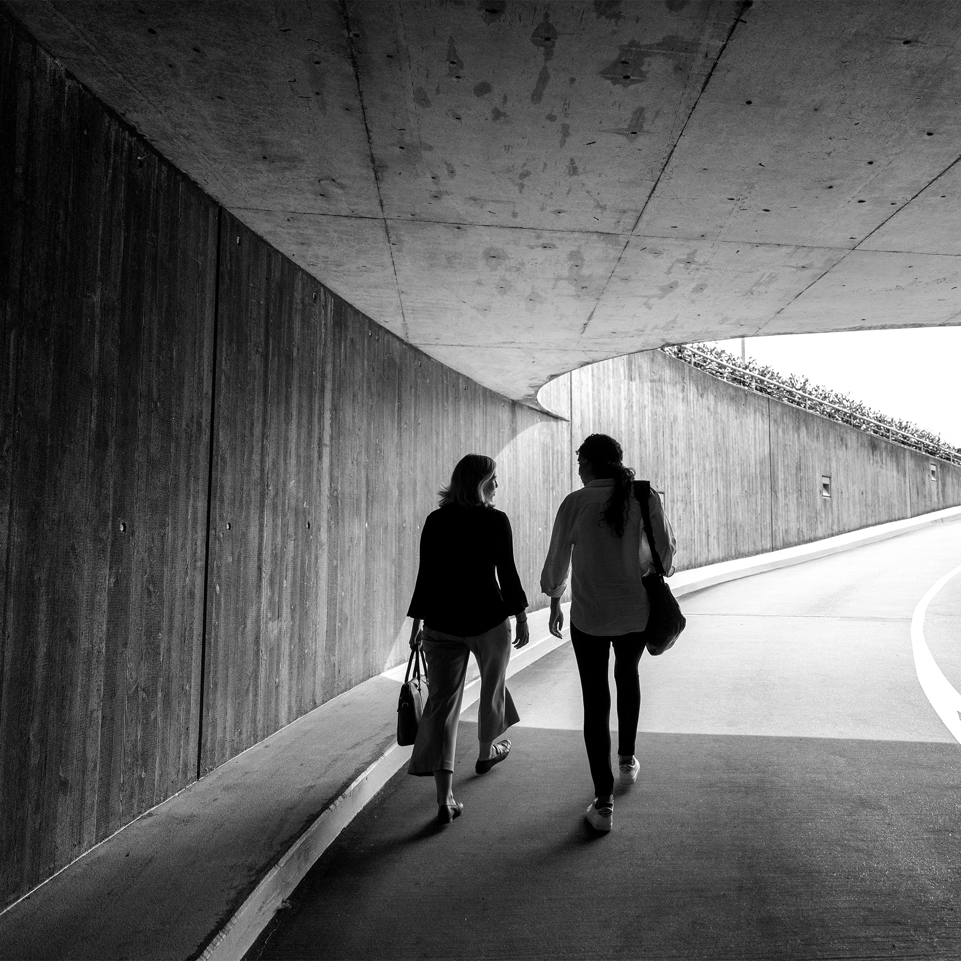 coworkers walking through parking garage